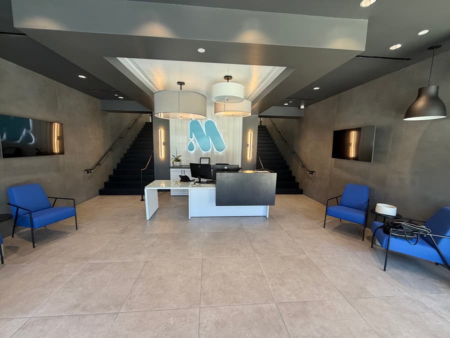 Commercial floor tile installation across a wide public-facing space.